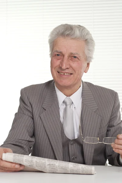 An businessman in glasses sitting — Stock Photo, Image