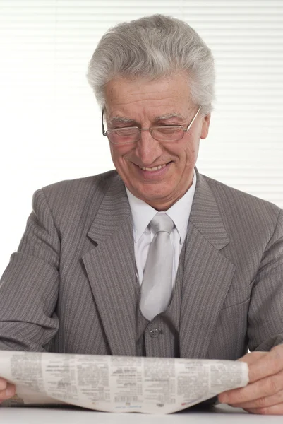 An businessman in glasses sitting — Stock Photo, Image