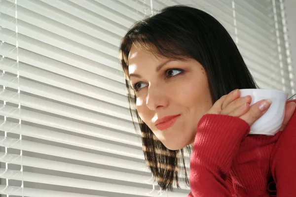 Happy Caucasian woman standing with a cup — Stock Photo, Image