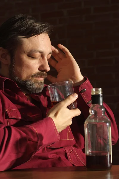 Caucasian man with a nice bottle sitting — Stock Photo, Image