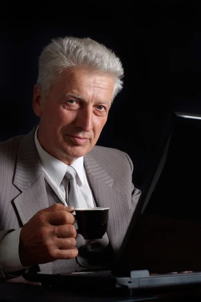 Imposing old man in suit with a cup of tea — Stock Photo, Image