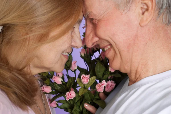 Happy Caucasian elderly stand together with the flower Stock Image