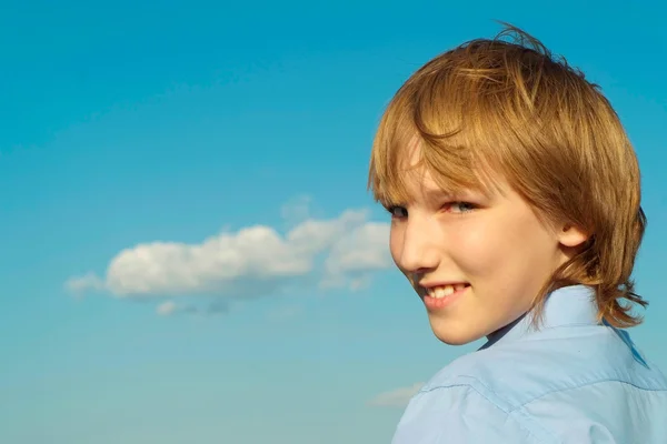 Jongen onder een blauwe lucht — Stockfoto