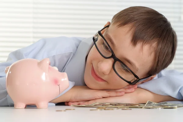 A young Caucasian nice business man is looking at a piggy bank — Stock Photo, Image