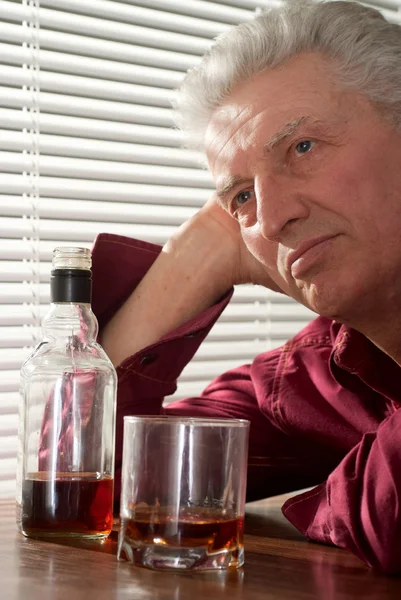 Nice male with a nice bottle sitting — Stock Photo, Image