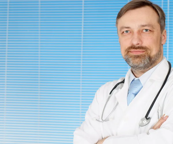 Attractive male doctor in his office — Stock Photo, Image