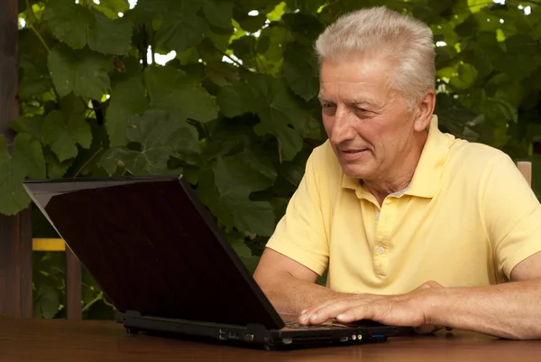 Cute older man sitting on the veranda — Stock Photo, Image