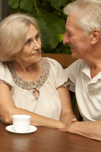 Adorable elderly couple sitting on the veranda — Stock Photo, Image