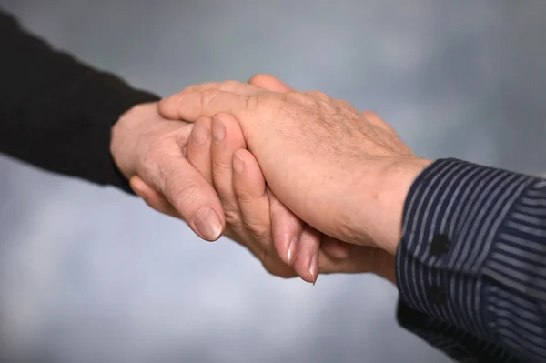 Two hands over gray background — Stock Photo, Image