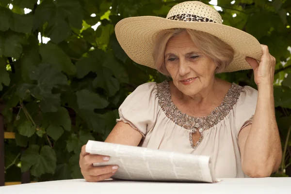 Sweet older woman sitting on the veranda — Stock Photo, Image