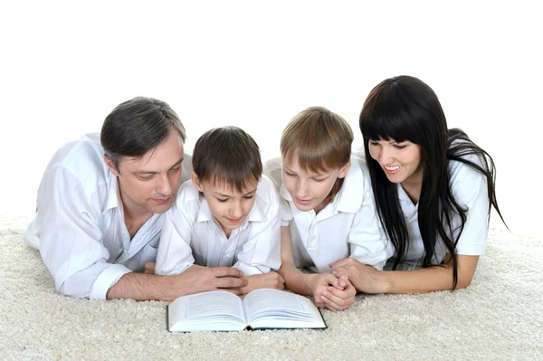 Three people reading a book on — Stock Photo, Image
