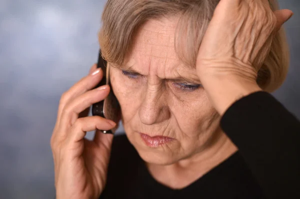 Sad old woman calling — Stock Photo, Image
