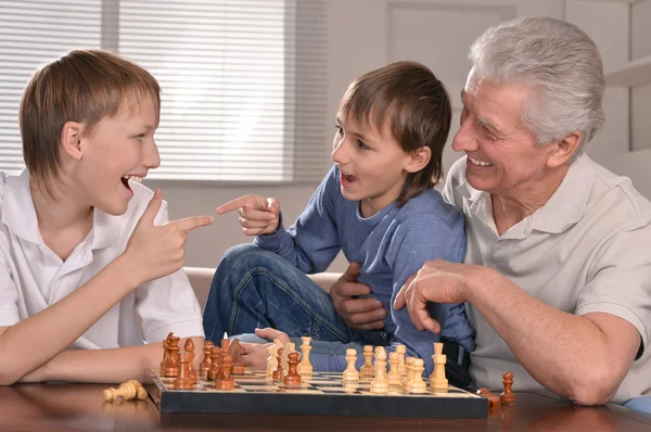 Happy family at a chess — Stock Photo, Image