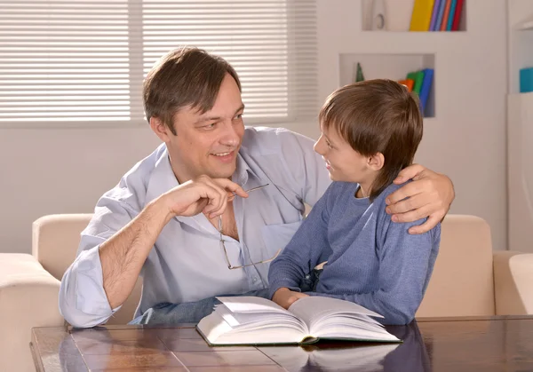 Father and his son sitting on sofa — Stock Photo, Image