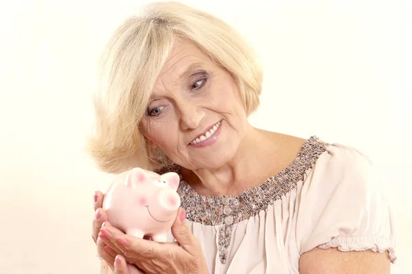 Mature woman with moneybox — Stock Photo, Image