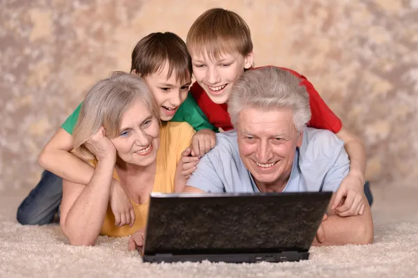 Mature couple and their grandchildren — Stock Photo, Image