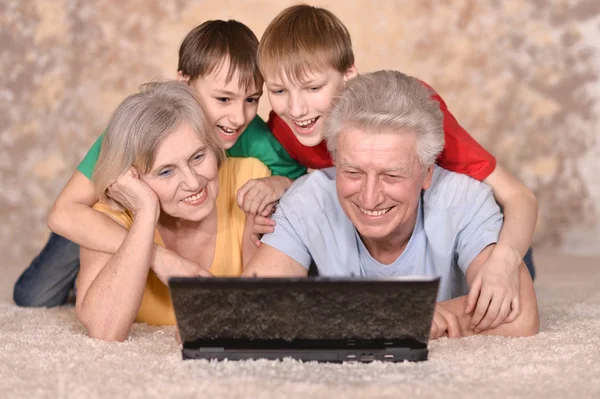Mature couple and their grandchildren — Stock Photo, Image