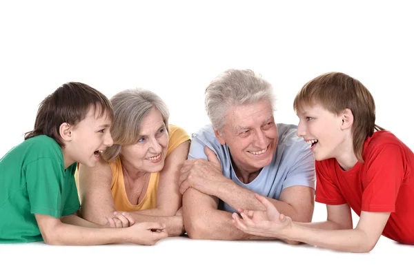 Two boys and their grandparents lying — Stock Photo, Image