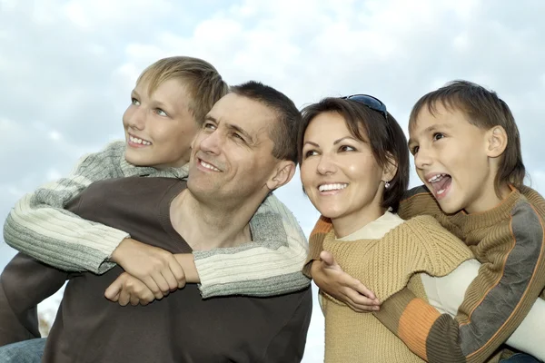 Family on a background of the sky — Stock Photo, Image