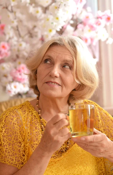 Elderly woman drinking tea — Stock Photo, Image