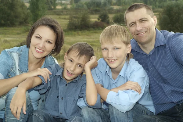 Happy family in a blue shirts — Stock Photo, Image