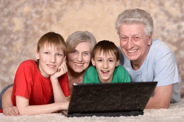 Mature couple and their grandchildren — Stock Photo, Image