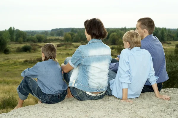 Happy family in a blue shirts — Stock Photo, Image