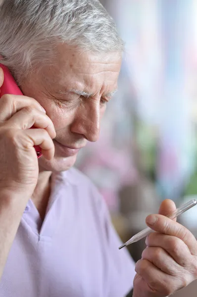 Elderly man calling to the doctor — Stock Photo, Image