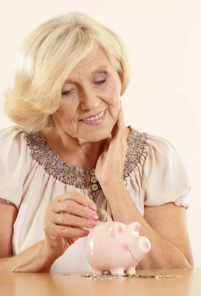 Mature woman with moneybox — Stock Photo, Image