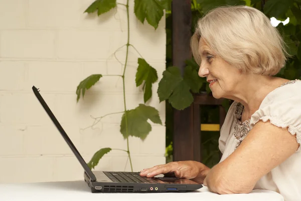 Good older woman sitting on the veranda — Stock Photo, Image