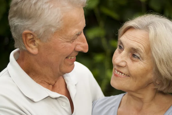 Beautiful elderly couple in the garden — Stock Photo, Image