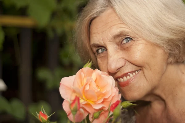 Amusing older woman sitting on the veranda — Stock Photo, Image