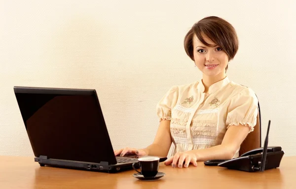 Nice young girl with a laptop — Stock Photo, Image