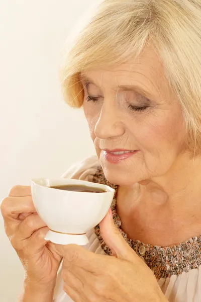 Old woman with coffee — Stock Photo, Image