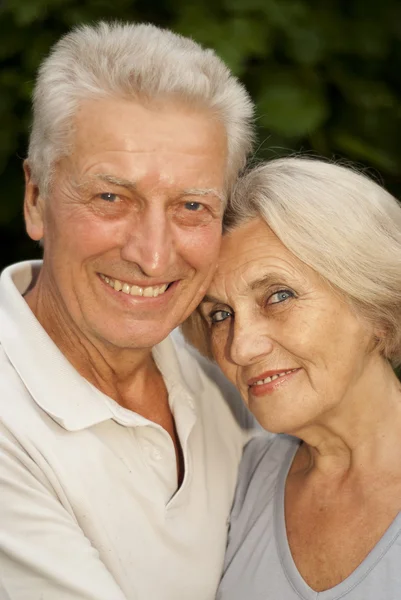 Beauteous elderly couple in the garden — Stock Photo, Image