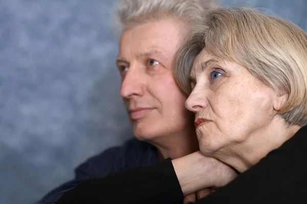 Elderly couple on a gray background — Stock Photo, Image