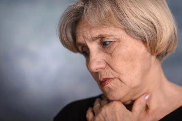 Pensive elderly woman — Stock Photo, Image