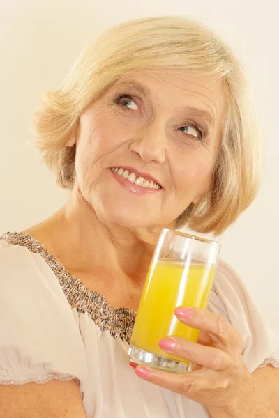 Woman with juice on the beige Royalty Free Stock Images