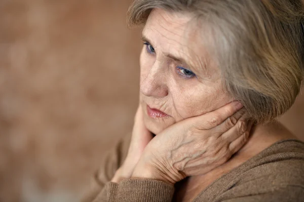 Elderly woman in a beige sweater Stock Image