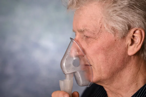 Elder man making inhalation — Stock Photo, Image