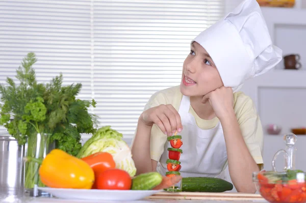Lindo chico preparando comidas vegetarianas en la cocina — Foto de Stock