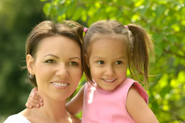 Beautiful young woman brought to walk her little daughter — Stock Photo, Image