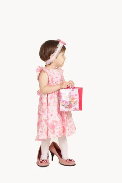 Cute little girl in a pink dress on a white background — Stock Photo, Image