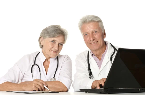 Elderly doctors with a laptop on a white — Stock Photo, Image