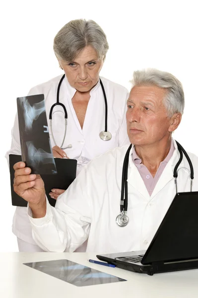 Elderly man and woman doctors exemining x-ray — Stock Photo, Image