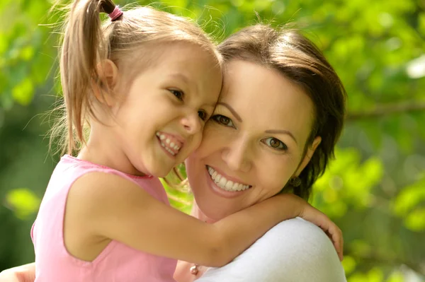 Beautiful young woman brought to walk her little daughter Stock Picture