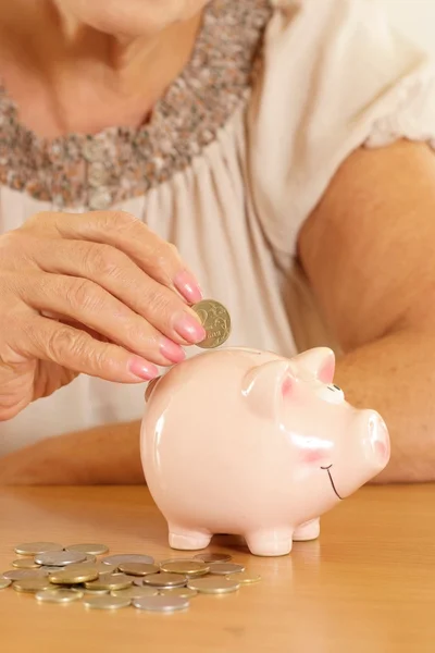 Woman with piggy bank on a beige — Stock Photo, Image