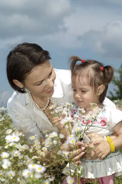 Beautiful mom holding her daughter — Stock Photo, Image