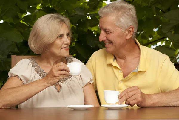 Adorable older couple sitting on the veranda — Stock Photo, Image