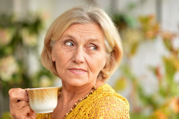 Happy nice elderly woman drinking — Stock Photo, Image